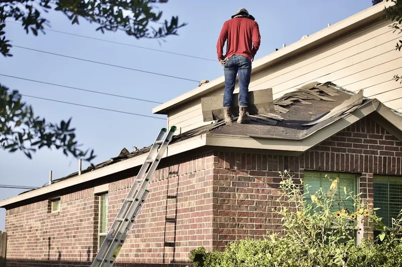 Professional roofer working on a residential roof in Stewarts Purchase